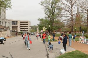 People standing on sidewalk for parade