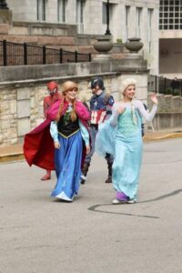 Anna and Elsa walking in parade