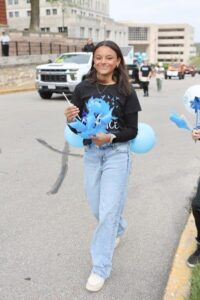 Woman handing out pinwheels