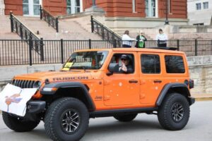 Man waving from Jeep
