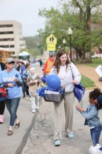 Woman interacting with little girl in parade