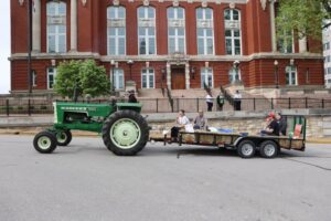 Oliver tractor pulling trailer in parade