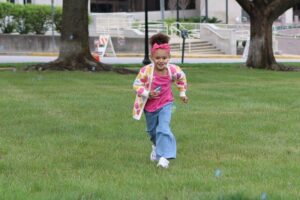 Little girl chasing bubbles