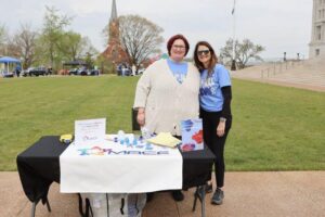 Two woman standing next to table