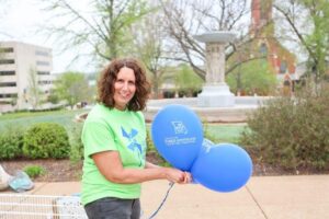Woman hold balloons to hand out at parade